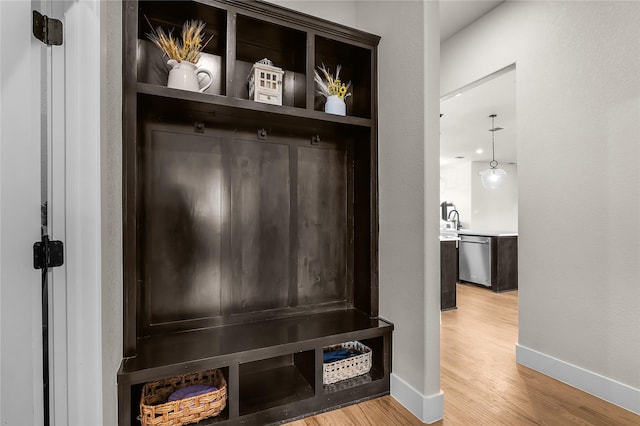 mudroom featuring baseboards and light wood finished floors