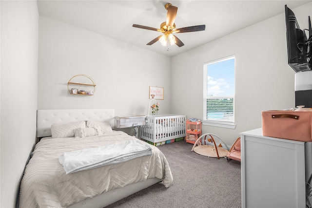 bedroom with a ceiling fan and carpet