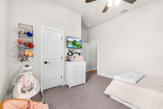 bedroom featuring visible vents, light colored carpet, baseboards, and ceiling fan