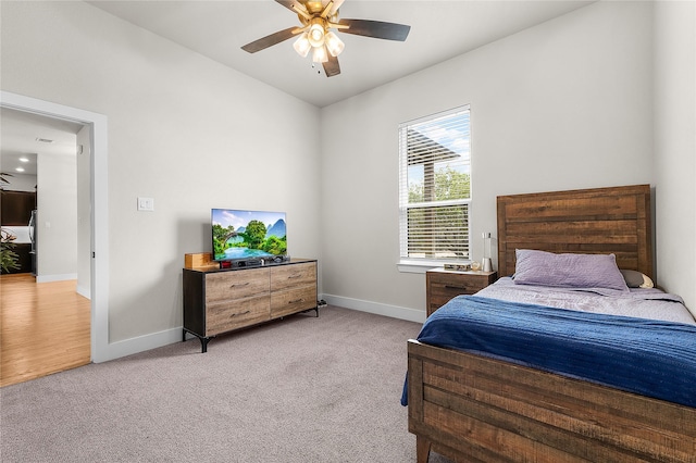 bedroom with ceiling fan, visible vents, baseboards, and light carpet