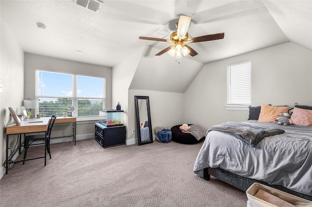 bedroom featuring vaulted ceiling, multiple windows, light colored carpet, and visible vents