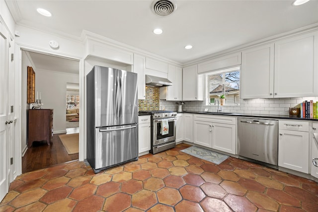 kitchen with dark countertops, visible vents, ventilation hood, crown molding, and stainless steel appliances