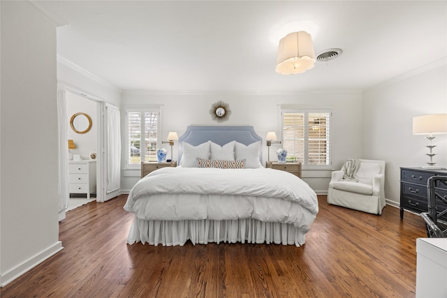 bedroom with crown molding, wood finished floors, and baseboards