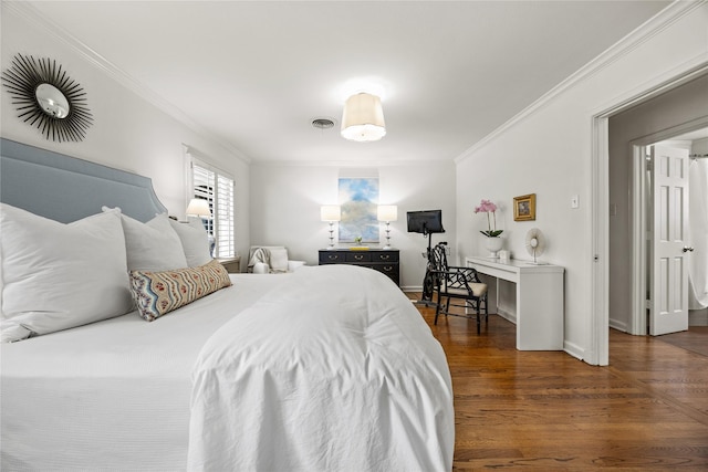 bedroom with visible vents, wood finished floors, baseboards, and ornamental molding