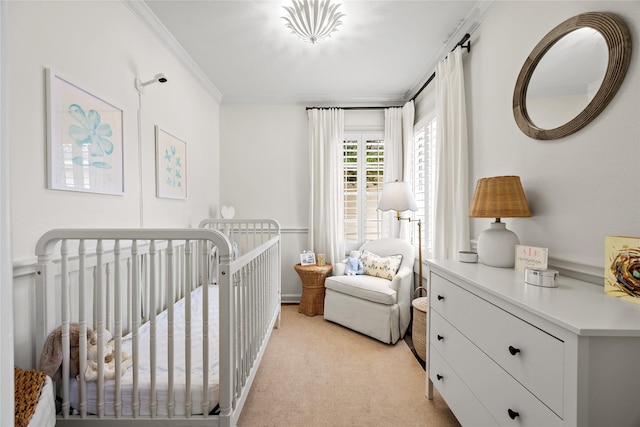 bedroom featuring crown molding, a nursery area, and light carpet