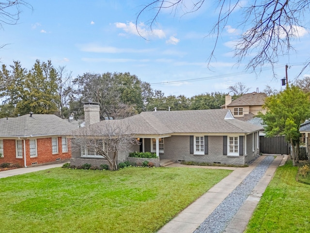 view of front facade featuring brick siding, fence, a front yard, a chimney, and crawl space