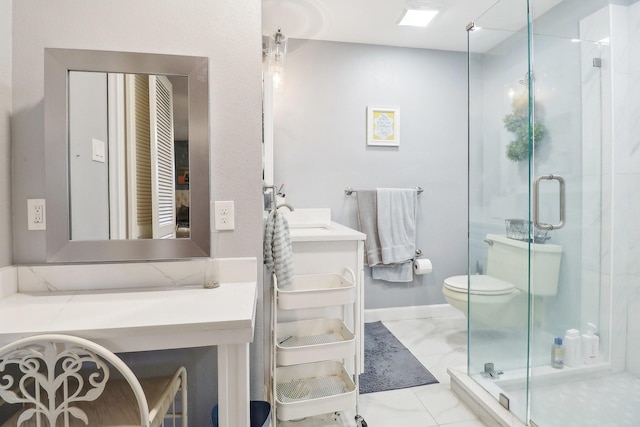 bathroom with toilet, marble finish floor, a stall shower, and vanity