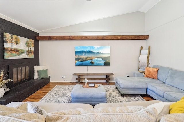 living room with a fireplace, lofted ceiling, and wood finished floors