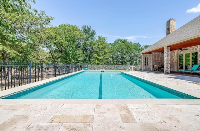 712 S Sugartree Dr, Lipan, TX 76462 - view of swimming pool featuring a ceiling fan, a patio area, and view of wooded area