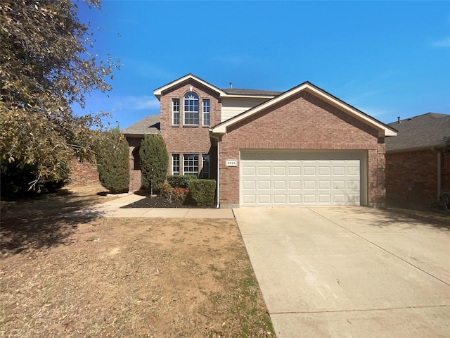 traditional-style home with brick siding, concrete driveway, and a garage