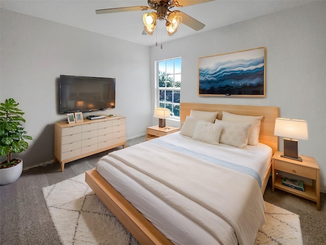 carpeted bedroom featuring baseboards and a ceiling fan