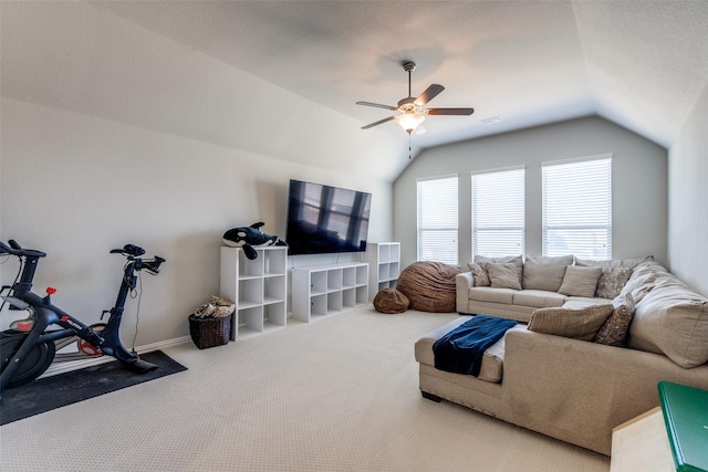 carpeted living area featuring visible vents, lofted ceiling, baseboards, and ceiling fan