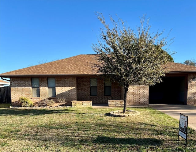 view of front of property featuring brick siding, driveway, a front yard, and a garage