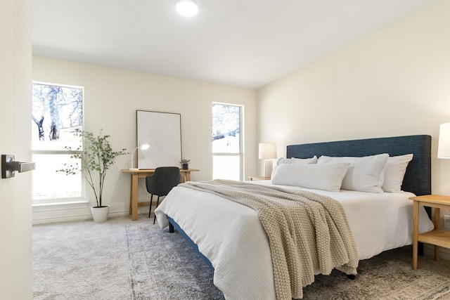 carpeted bedroom featuring baseboards