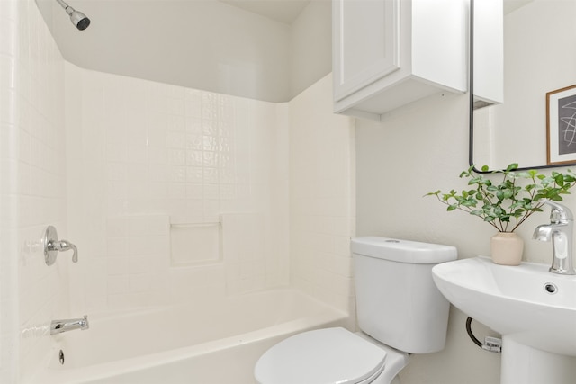 bathroom with a sink, toilet, and  shower combination