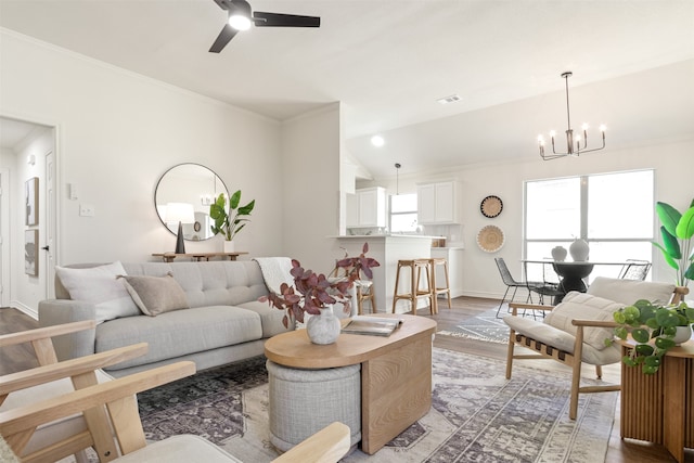 living room featuring a healthy amount of sunlight, crown molding, and wood finished floors