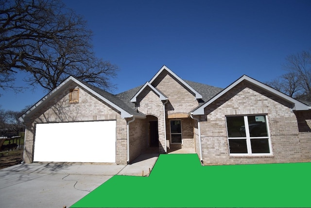 view of front facade featuring brick siding and an attached garage