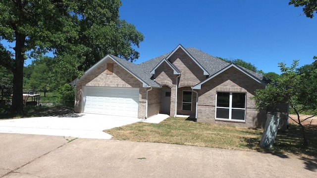 110 Saint Francis Ln, Mabank, TX 75156 - view of front facade with an attached garage, driveway, a front yard, and brick siding