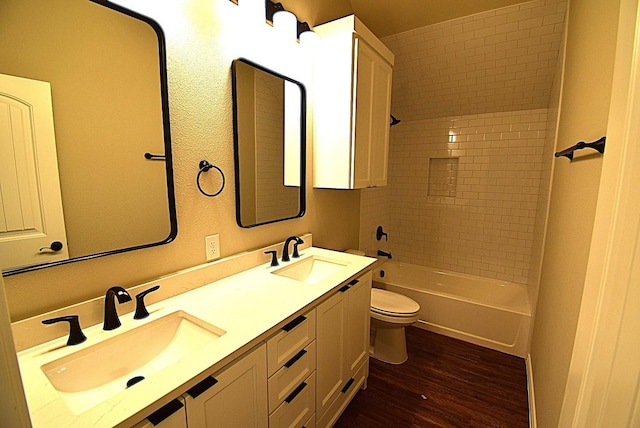 110 Saint Francis Ln, Mabank, TX 75156 - bathroom with wood finished floors, toilet, double vanity, and shower / bathtub combination
