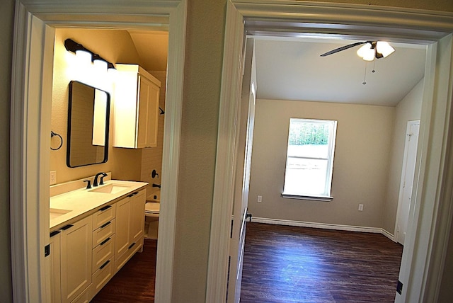 110 Saint Francis Ln, Mabank, TX 75156 - full bathroom featuring wood finished floors, double vanity, toilet, a ceiling fan, and lofted ceiling