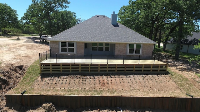 110 Saint Francis Ln, Mabank, TX 75156 - back of property featuring a deck, brick siding, a chimney, and a shingled roof
