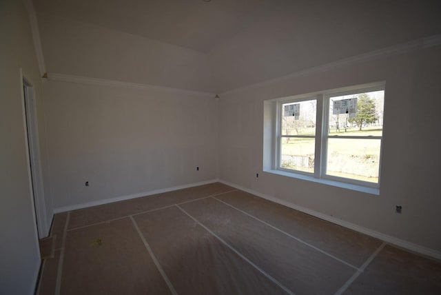 spare room featuring baseboards, lofted ceiling, and ornamental molding