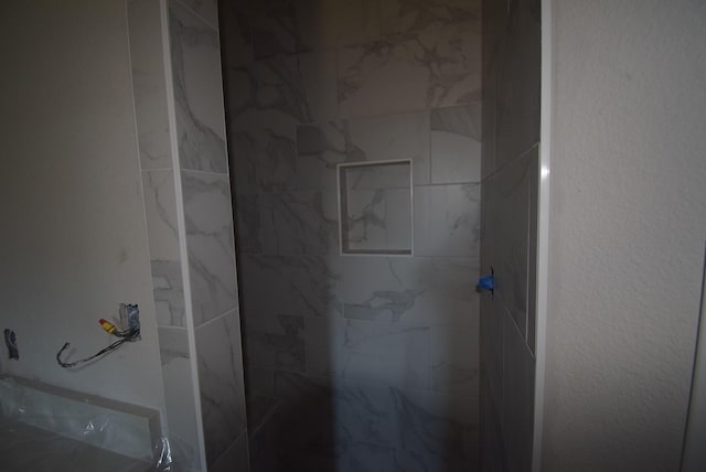 full bathroom with a tile shower