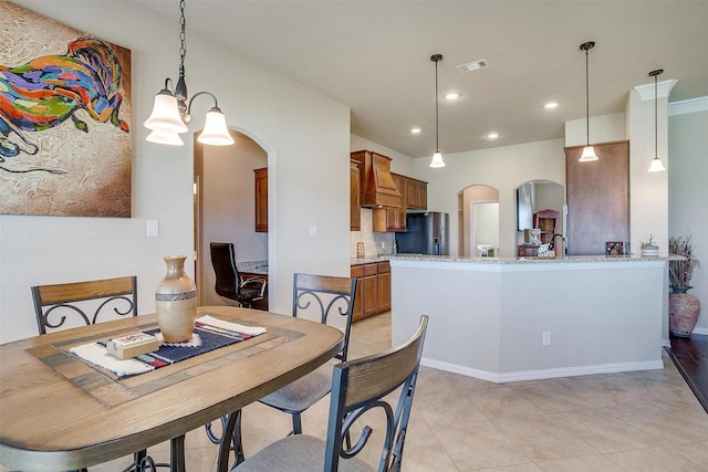 dining room with recessed lighting, visible vents, arched walkways, and a chandelier