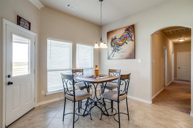 dining area with visible vents, arched walkways, and light tile patterned flooring