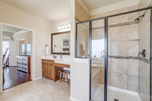 bathroom with tile patterned floors, a stall shower, and vanity