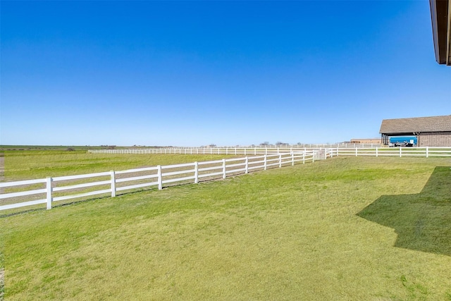 view of yard featuring a rural view and fence