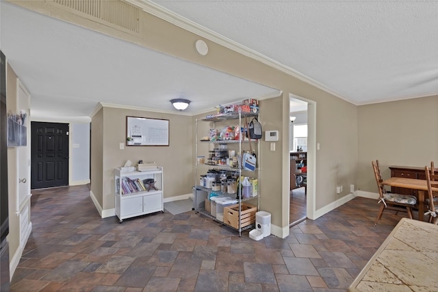 interior space with visible vents, stone finish flooring, crown molding, baseboards, and a textured ceiling