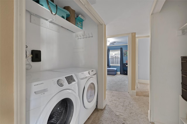 washroom featuring light carpet, laundry area, independent washer and dryer, and baseboards