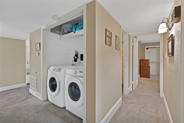 washroom with washer and dryer, baseboards, carpet floors, and laundry area