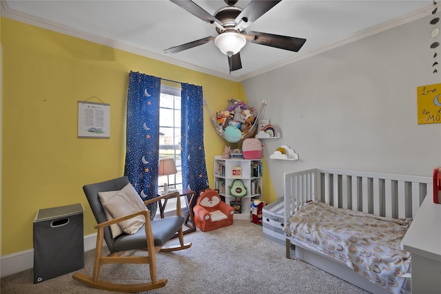 carpeted bedroom featuring ceiling fan, baseboards, and ornamental molding