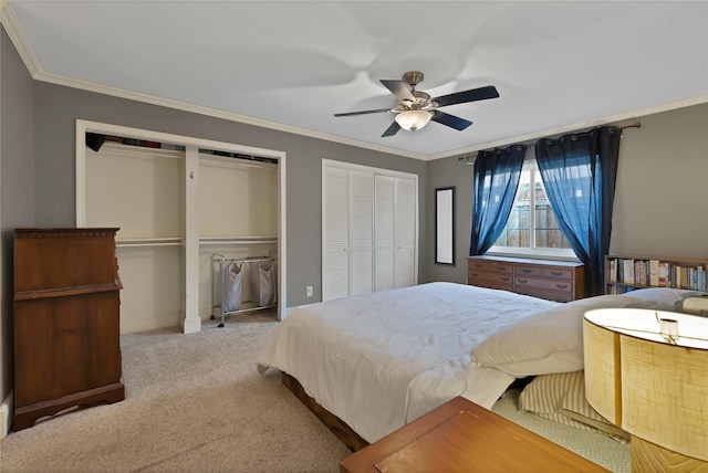 bedroom featuring baseboards, multiple closets, ornamental molding, carpet flooring, and a ceiling fan