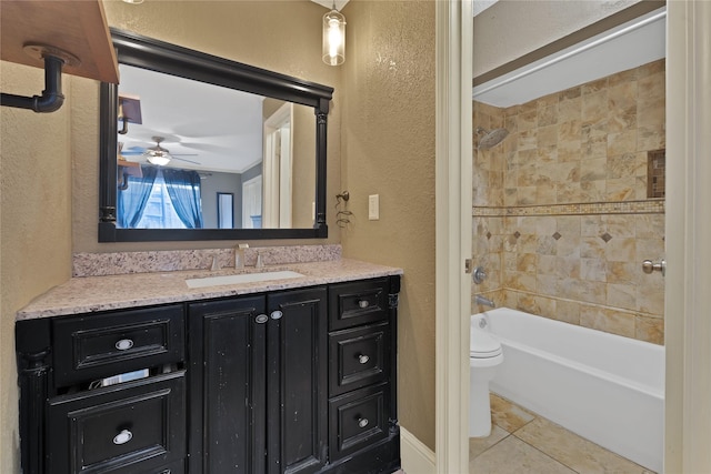 bathroom with toilet, shower / washtub combination, vanity, and a textured wall