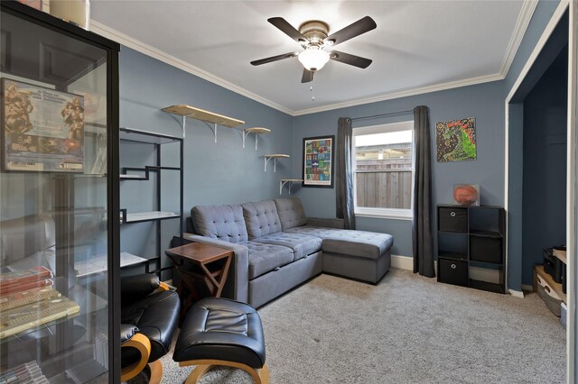 living room featuring baseboards, carpet, ornamental molding, and a ceiling fan