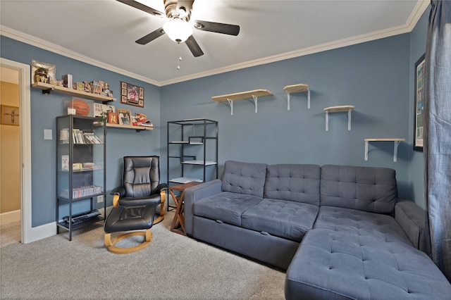 living area with baseboards, carpet, ornamental molding, and a ceiling fan