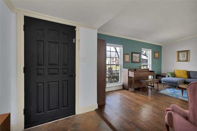 entryway with wood finished floors, baseboards, and ornamental molding