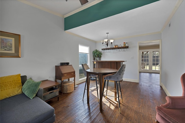 dining space featuring a notable chandelier, plenty of natural light, baseboards, and dark wood-style flooring