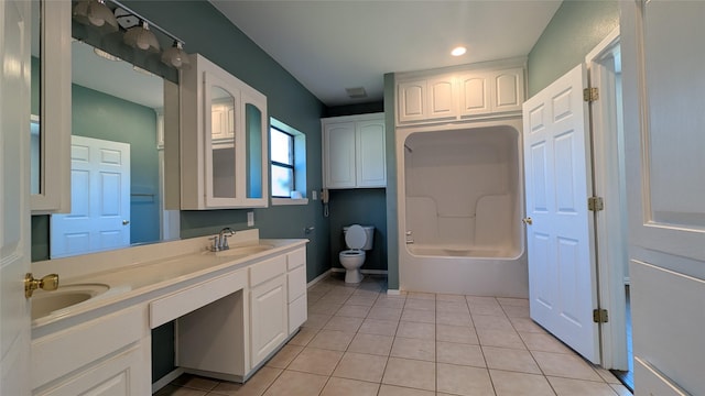 full bath featuring tile patterned flooring, double vanity, toilet, and a sink