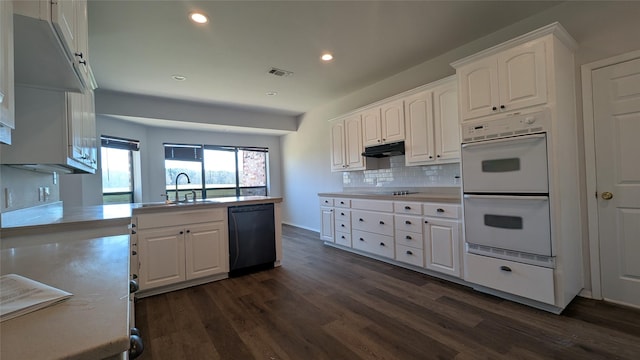 kitchen with under cabinet range hood, visible vents, white cabinets, and black appliances