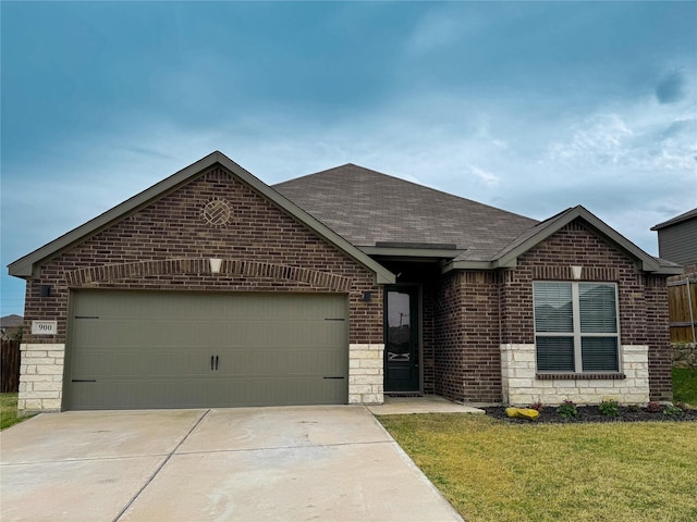 ranch-style home with driveway, roof with shingles, a garage, stone siding, and brick siding