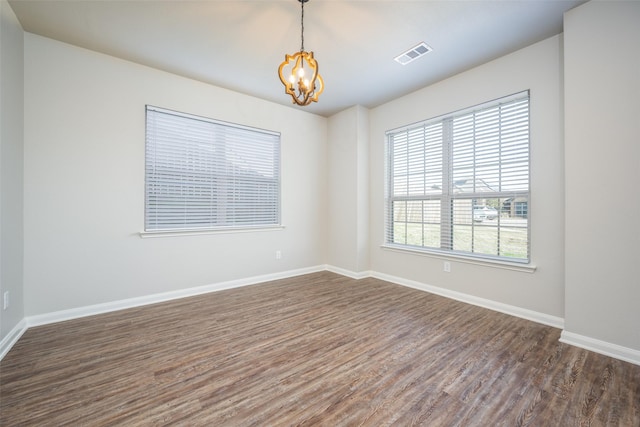 900 Juneberry Dr, Denton, TX 76207 - unfurnished room featuring visible vents, baseboards, a notable chandelier, and dark wood-style floors