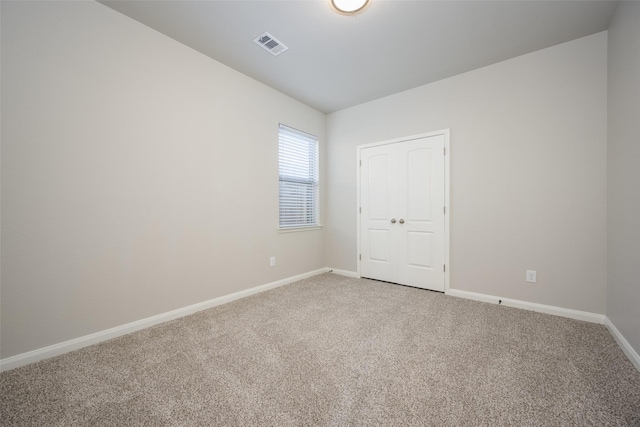 900 Juneberry Dr, Denton, TX 76207 - spare room with light colored carpet, visible vents, and baseboards