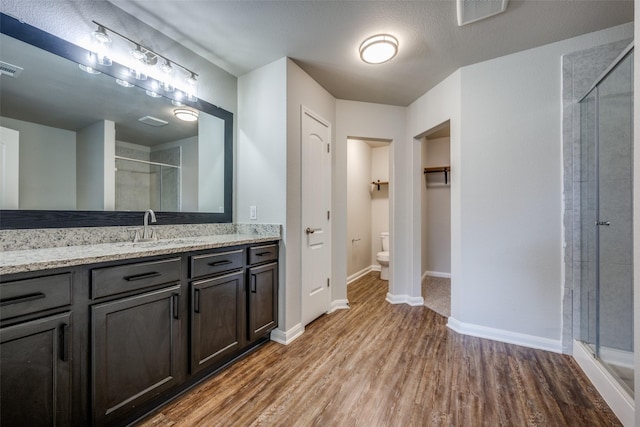 900 Juneberry Dr, Denton, TX 76207 - full bath with visible vents, a shower stall, toilet, wood finished floors, and vanity