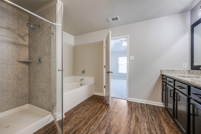 900 Juneberry Dr, Denton, TX 76207 - full bath featuring visible vents, tiled shower, wood finished floors, and vanity
