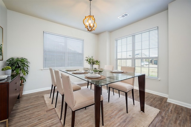 900 Juneberry Dr, Denton, TX 76207 - dining space featuring visible vents, wood finished floors, baseboards, and a chandelier