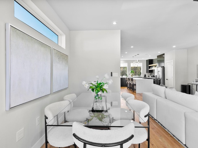 dining area with light wood-style flooring, recessed lighting, and a healthy amount of sunlight